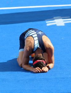 Exhausted man laying on the ground after running the finnish